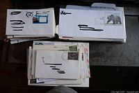 Stacks of first day cover envelopes with visible stamps and postmarks