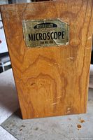 Front of oak case showing Skilcraft Microscope Lab No. 454 label