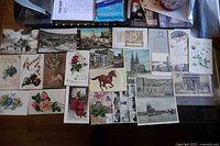 Group shot of all 23 vintage postcards laid out