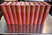 Front spines of ten red cloth volumes