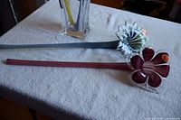 Both Murano glass flowers laid on table, showing full length and stems
