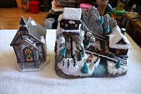 Overview of church and mountain scene pieces on table