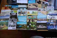 All 65 postcards laid out in rows showing fronts and variety of images