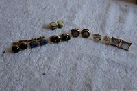 All cufflinks and studs laid out on cloth