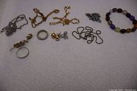 All ten jewelry pieces laid out on surface