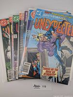 Stack of eight bagged DC comics, top shows Unexpected House on Edge of Eternity