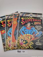 Front view showing four bagged 1970s Superman comic books, including two copies of issue #300