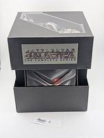 Front view of collector box partially opened showing metal plaque and interior cases