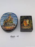 Both lacquer boxes closed, top artwork visible