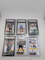Front view of six graded NHL trading cards in slabs
