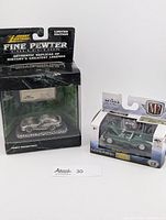 Front view of both boxed model cars