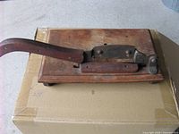Top view of tobacco cutter showing blade, handle and base