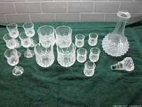 Group shot of decanter, stopper, five large tumblers, four small tumblers, four stemmed liqueur glasses