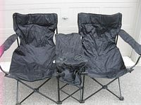 Front view of folded-out double camp chair showing both seats and centre beverage holder section