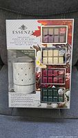 Front of sealed Essenza wax warmer kit showing warmer and four wax melt packs