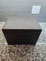Closed brown faux leather jewelry box