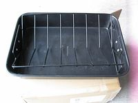 Top view of black roasting pan with wire rack inserted