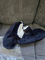 Booties side view showing exterior plush fabric and tag