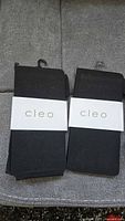 Two folded black Cleo leggings with brand bands