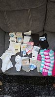 All socks laid out on couch showing quantity and variety