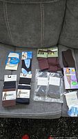 All packaged socks and hosiery displayed on sofa
