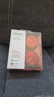 Front view of sealed Sony MDR-ZX310 red headphones in package