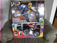 Front view of both boxed RC toys on chair