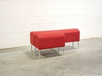 Long and short red wool benches on concrete floor