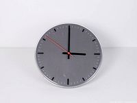 Front view of circular grey IKEA wall clock showing full face and hands