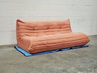 Front angled view of dusty pink Togo-style sofa