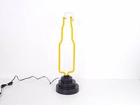Full view of neon lamp unlit showing bottle outline and base with power cord