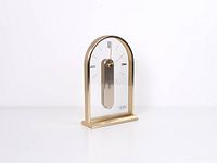 Left angled view of gold-tone Citizen quartz mantel clock showing overall design and clear acrylic panel