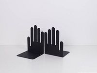 pair of black metal hand-shaped bookends front angled view