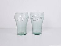 Front view of two green Coca-Cola tumblers