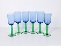 Front view of all six blue and green wine glasses in a row