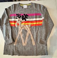 Full front view of grey Antoni & Alison sweater with reindeer graphic and stripes