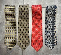 All four Canali silk ties laid flat showing patterns