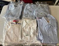 Six packaged shirts assorted colors and patterns