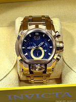 Front angled view of gold-tone Invicta Bolt Zeus watch in box