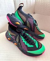 Pair of John Fluevog D.D.F.T Velocity Prism sneakers angled view showing knit pattern and color accents