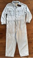Front view of Levi's light wash denim jumpsuit laid flat showing full length