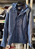 Front view of blue Weatherproof 32° coat on hanger