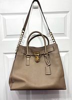 Full front view of the Michael Kors Hamilton tote showing overall design and shoulder strap