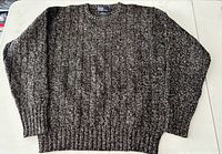 Front view of marled knit sweater laid flat