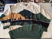 Full sweater front laid flat showing design and V-neck