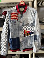 Front view of Smoke Rise denim varsity jacket hanging on hanger