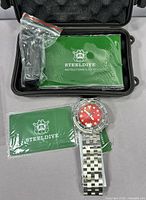 Watch with open Steeldive hard case, manuals and accessory packet