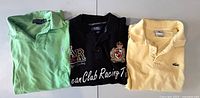 All three polo shirts laid out to show colors and logos