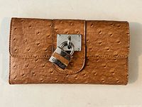 Front view showing padlock and ostrich embossing