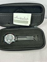 Watch in case with instruction booklet visible